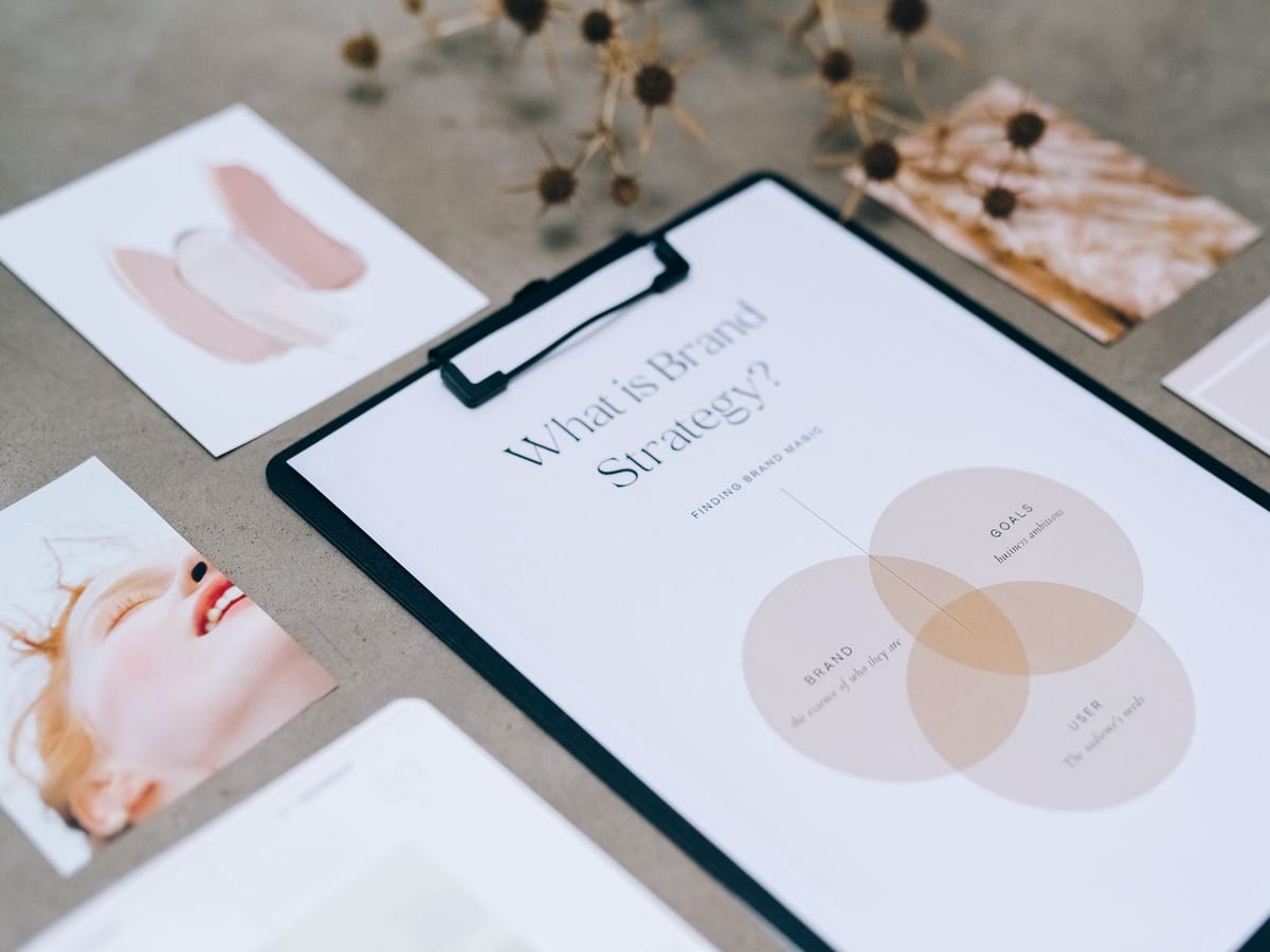 A brand and layout document on a designer’s desk